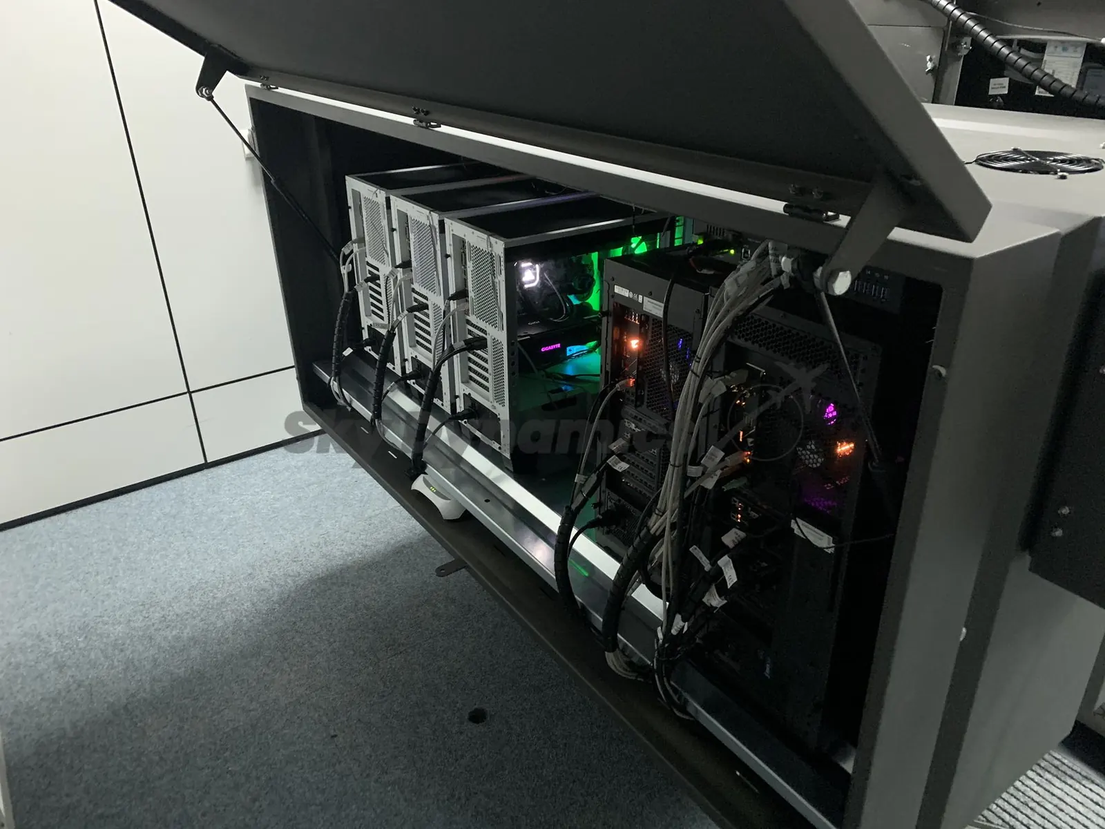 Computers inside the base of a SkyDynamics Bombardier Q400 procedures trainer, with the cover open