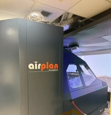 Enclosure of the A320 FNPT II simulator with the Airplan Aviation logo, the visual system behind it